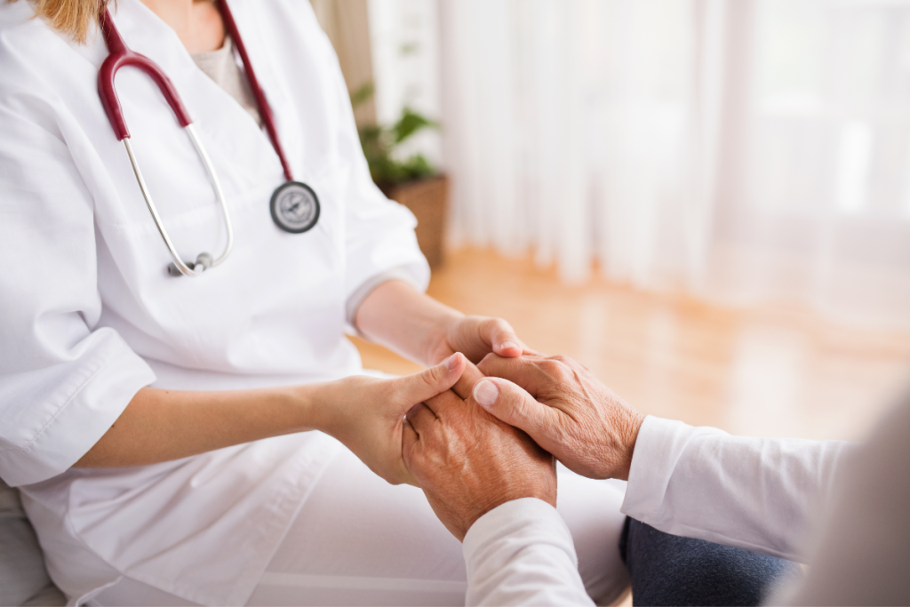 Doctor holding the hands of a patient to display support through dietary supplement options.