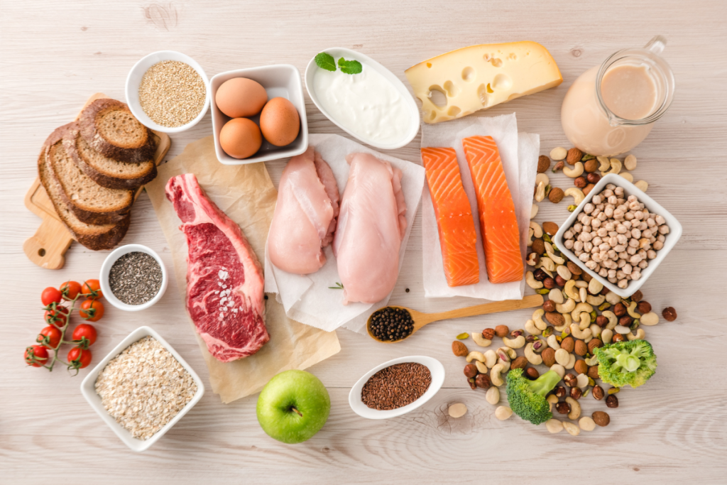 Above view of a table of foods that are high in protein and carbohydrates to resemble a healthy diet for individuals with ADHD.