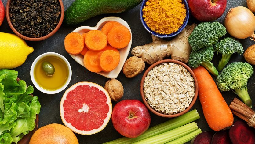 Above view of a table full of colorful fruits and vegetables. 